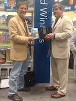 David Ripianzi, publisher of YMAA Publication Center, presents John Donohue, author of Enzan: The Far Mountain, a Connor Burke Martial Arts Thriller, with a certificate and trophy from IBPA Benjamin Franklin Awards.